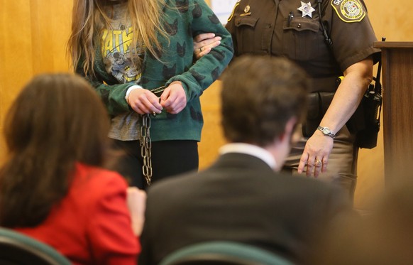 One of two girls, suspects in the Slenderman stabbing case is escorted into court in Milwaukee on Friday, March 13, 2015. On Friday, a judge decided to try the two 12-year-olds as adults. The two girl ...