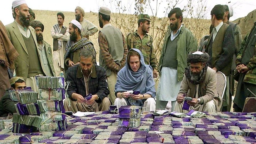 Bank officials and international observers are randomly counting several bundles of Afghan banknotes in an effort to detect any fraud in the process before they are destroyed by fire in an incinerator on Wednesday, December 11.  18, 2...