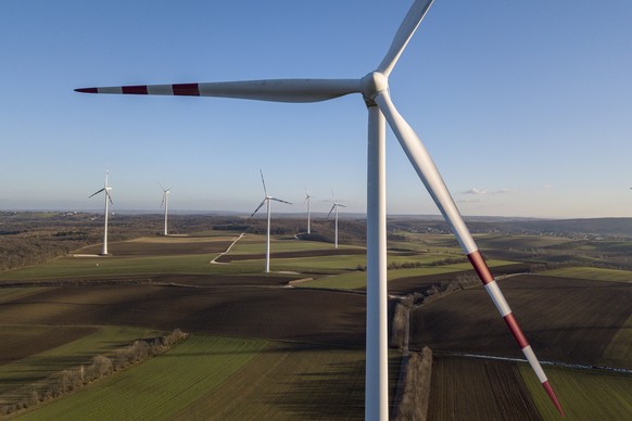 epa07210104 A picture taken with a drone showing wind turbines on fields on a sunny winter day near Herrnleis, some 50 kilometers northern Vienna, Austria, 05 December 2018. According to a report by t ...