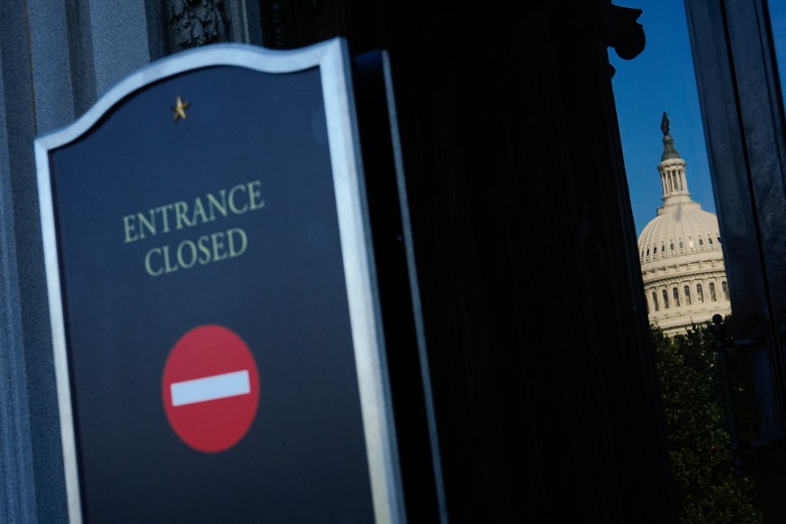 The U.S. Capitol is reflected in the doors of the Library of Congress, which is closed due to a partial government shutdown, Wednesday, Oct. 1, 2025, in Washington. (AP Photo/Julia Demaree Nikhinson)
 ...