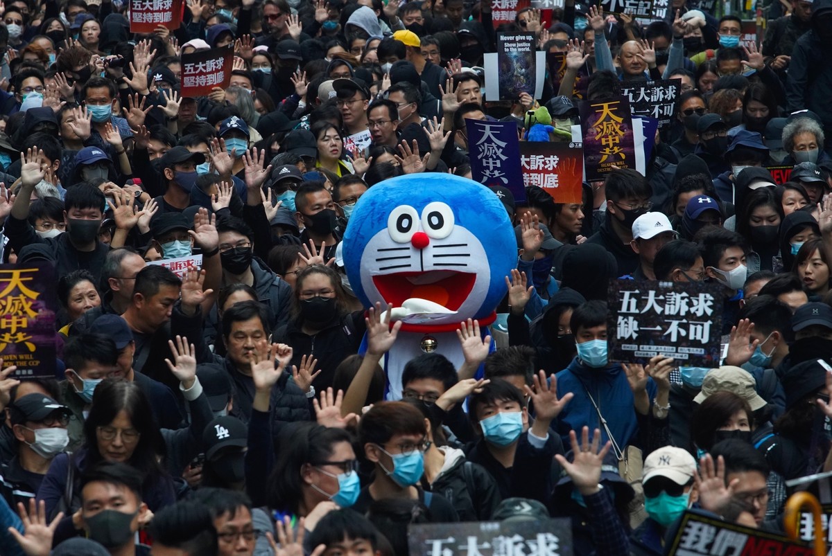 Hong Kong people participate in their annual pro-democracy march on New Year's Day to insist their five demands be matched by the government in Hong Kong, Wednesday, Jan. 1, 2020. The five demand ...