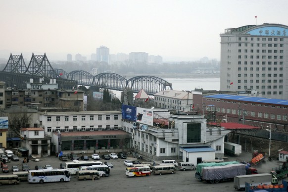 FILE - In this March 17, 2016, file photo, loaded trucks and vehicles wait in line at the border check point before crossing the Friendship Bridge linking China and North Korea across the Yalu River,  ...