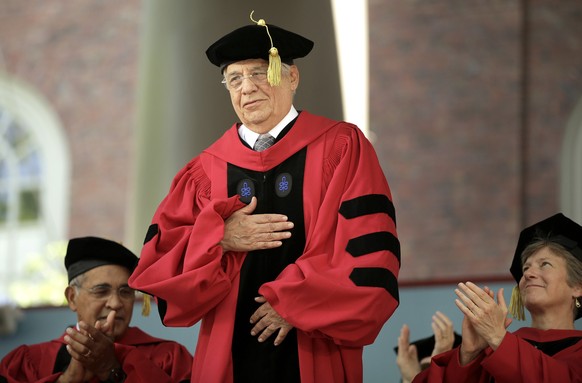Former President of Brazil Fernando Henrique Cardoso, center, places his hand on his chest as he is introduced before being conferred with an honorary doctor of laws degree as biographer and literary  ...