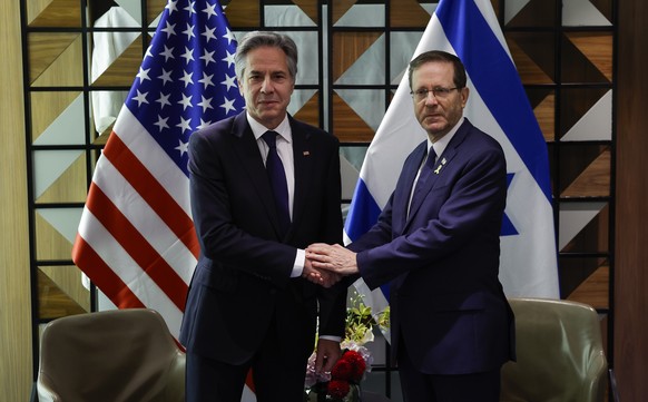 U.S. Secretary of State Antony Blinken, left, and Israeli President Isaac Herzog shake hands during their meeting in Tel Aviv, Israel Wednesday, May 1, 2024. (Evelyn Hockstein/Pool Photo via AP)