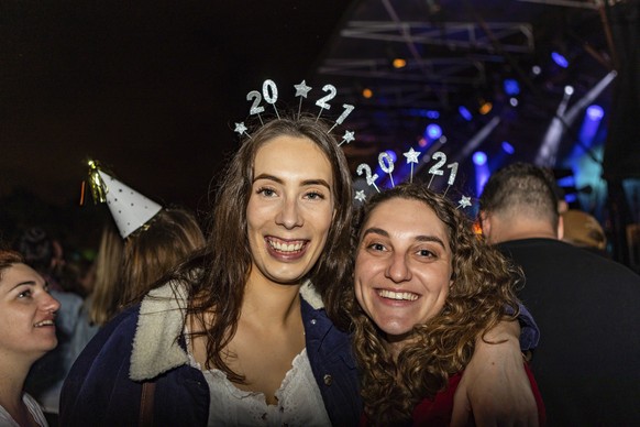 Sophie Jackson and Monique Lee, both from Christchurch, attend New Year celebrations in Hagley Park, Christchurch, New Zealand, Friday, Jan. 1, 2021. New Zealand and its South Pacific island neighbors ...