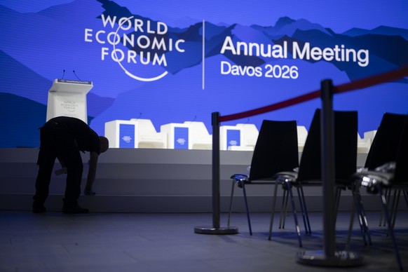A worker cleans the stage on the closing day of the 56th annual meeting of the World Economic Forum, WEF, in Davos, Switzerland, Friday, January 23, 2026. The meeting under the topic "A Spirit of ...