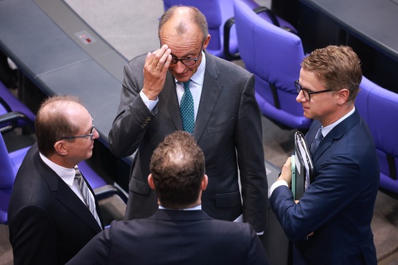 epa11595890 Chairman of the Christian Democratic Union (CDU) party and faction Friedrich Merz (C-back), Member of Parliament Jens Spahn (C-front), Christian Democratic Union (CDU) party secretary gene ...