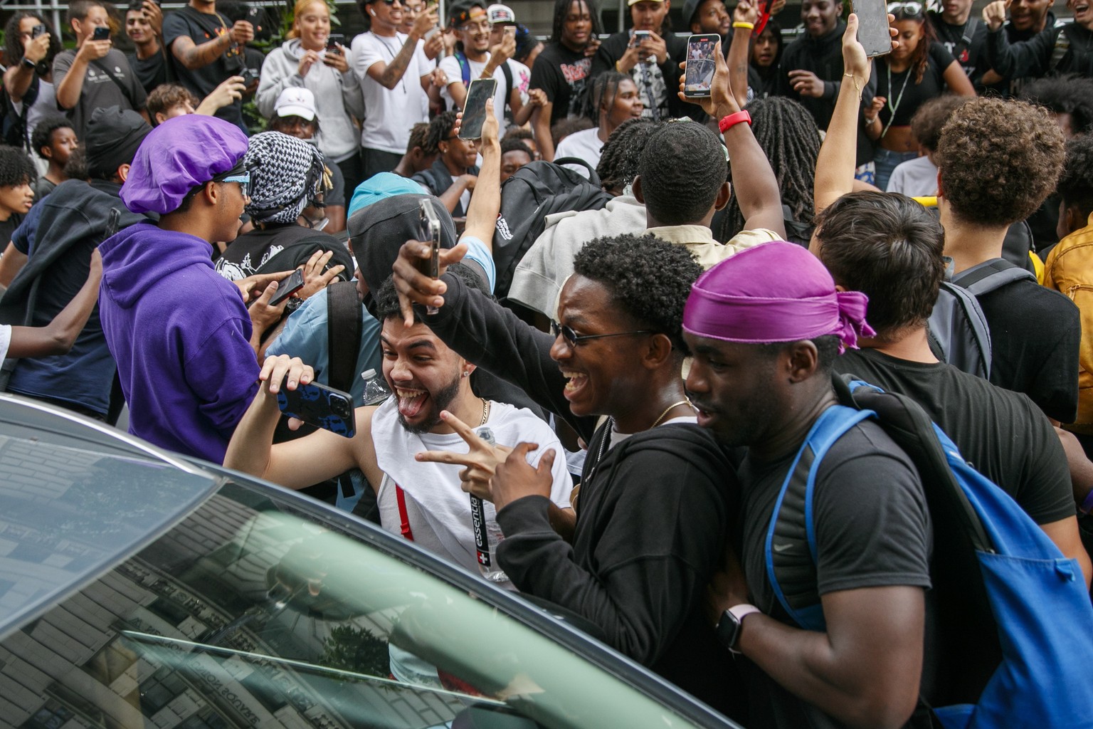 epa10785129 People swarm a car during unrest after a streamer attempted to hold a giveaway in New York, New York USA, 04 August 2023. Popular Twitch streamer, Kai Cenat, one of the most popular stream ...