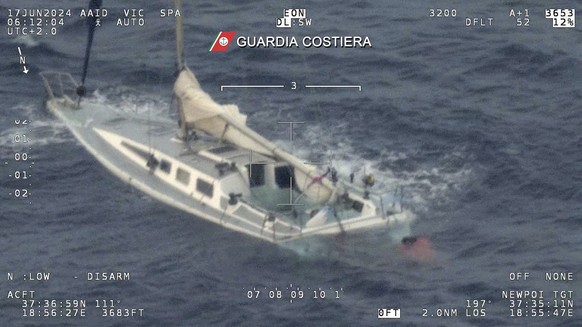 This picture taken early Monday, June 17, 2024 by the Italian Coast Guard shows a sail boat used by migrants half sank in the Mediterranean Sea between Italy and Greece early Monday, June 17, 2024. 12 ...