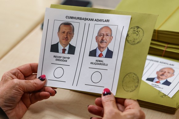 epa10659400 An election official holds ballots of presidential candidates at a polling station in Ankara, Turkey, 28 May 2023. General elections had been held in Turkey on 14 May, where none of the ca ...