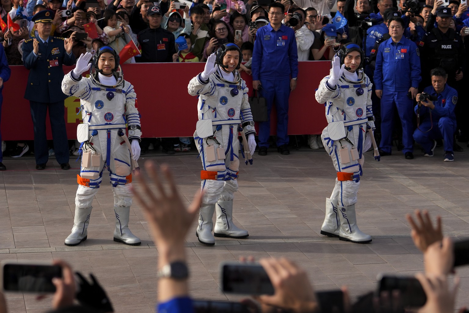Chinese astronauts for the Shenzhou-18 mission, from right, Ye Guangfu, Li Cong, and Li Guangsu wave as they attend a send-off ceremony for their manned space mission at the Jiuquan Satellite Launch C ...