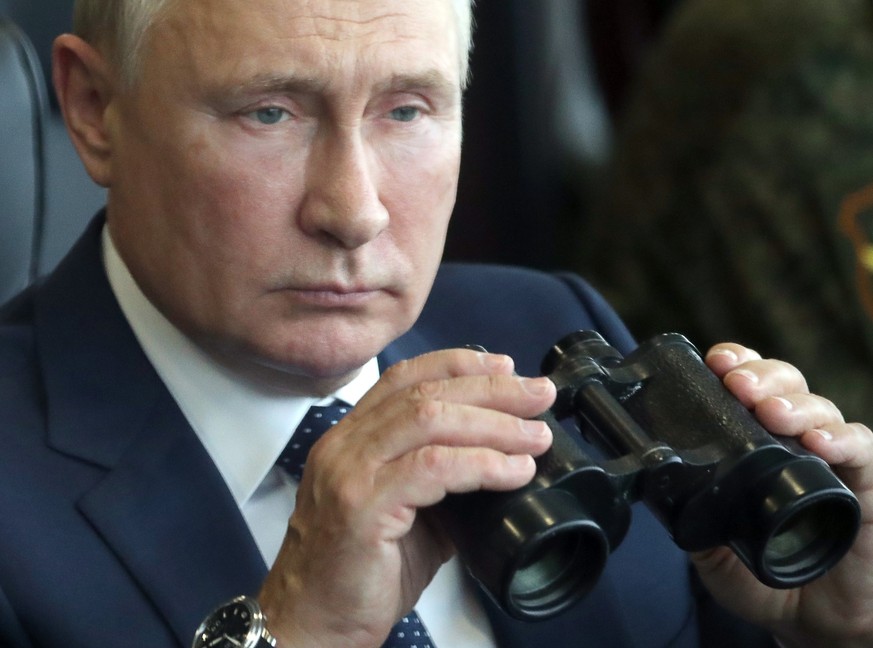 FILE - Russian President Vladimir Putin holds a binoculars as he watches the joint strategic exercise of the armed forces of the Russian Federation and the Republic of Belarus Zapad-2021 at the Mulino ...