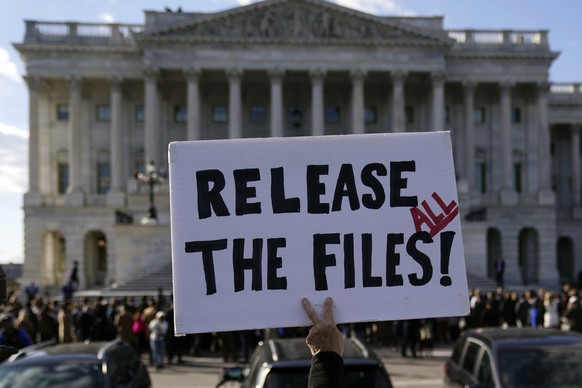 epa12521494 A protester holds a sign asking for the release of the Epstein files outside the US Capitol in Washington, DC, USA, 12 November 2025. House Democrats released emails on 12 November from Je ...