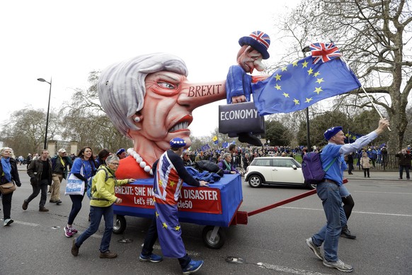 Demonstrators pull a cart with a doll resembling British Prime Minister Theresa May during a Peoples Vote anti-Brexit march in London, Saturday, March 23, 2019. The march, organized by the People&#039 ...
