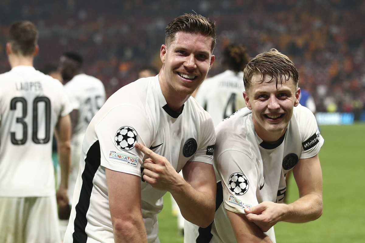 YB's Cedric Itten, left, and Lewin Blum celebrate their victory after the Uefa Champions League playoff soccer match between Turkey's Galatasaray Istanbul and Switzerland's BSC Young Bo ...