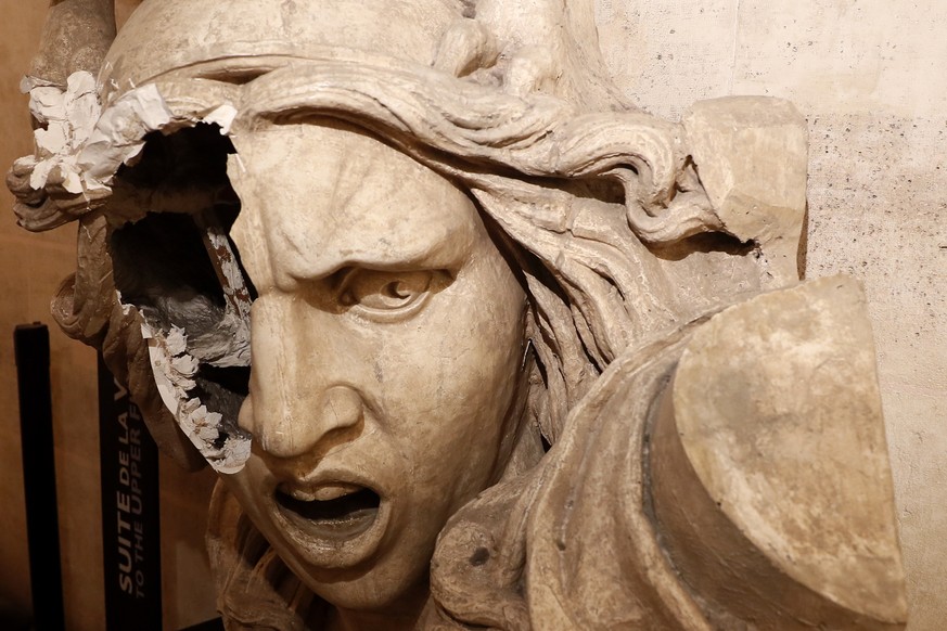 epa07202576 A vandalizes statue of the Marianne, a symbol in France, seen inside the Arc de Triomphe, as protesters wearing yellow vests (gilets jaunes) entered the Arc de Triomphe monument during cla ...