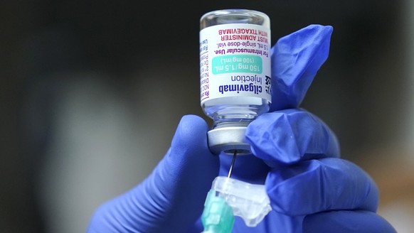 FILE - Jose Lazaro, a medical assistant at a University of Washington Medicine clinic, prepares a two-shot dose of AstraZeneca's Evusheld, the first set of antibodies grown in a lab to prevent CO ...