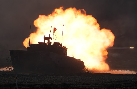 A Japanese Ground-Self Defense Force (JGDDF) Type 90 tank fires its gun at a target during the annual drill with live ammunitions exercise at Minami Eniwa Camp Monday, Dec. 6, 2021, in Eniwa, on the n ...