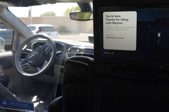 A Waymo minivan arrives to pick up passengers for an autonomous vehicle ride, Wednesday, April 7, 2021, in Mesa, Ariz. Waymo, a unit of Google parent Alphabet Inc., is one of several companies testing ...