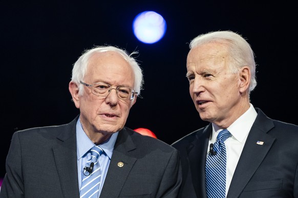 epa08351090 (FILE) - Democratic presidential candidates Bernie Sanders (L) and Joe Biden (R) chat on stage during the tenth Democratic presidential debate at the Gaillard Center in Charleston, South C ...