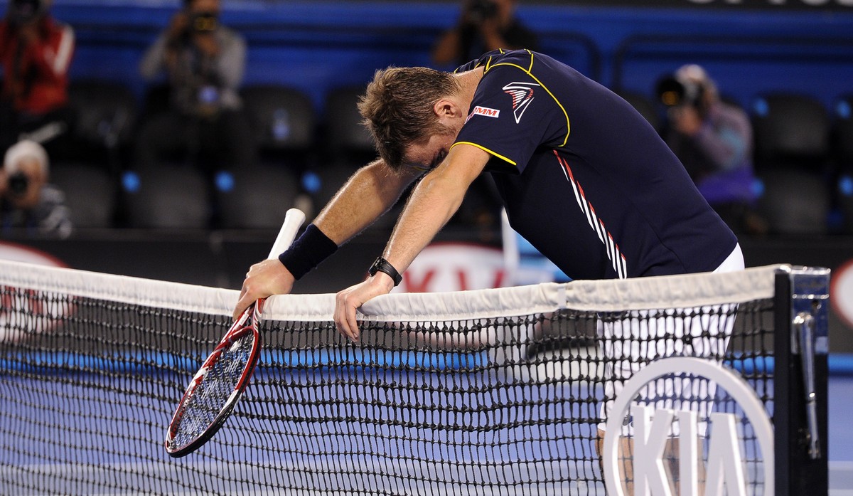 Switzerland's Stanislas Wawrinka rests on the net after losing his fourth round match against Serbia's Novak Djokovic at the Australian Open tennis championship in Melbourne, Australia, Sund ...