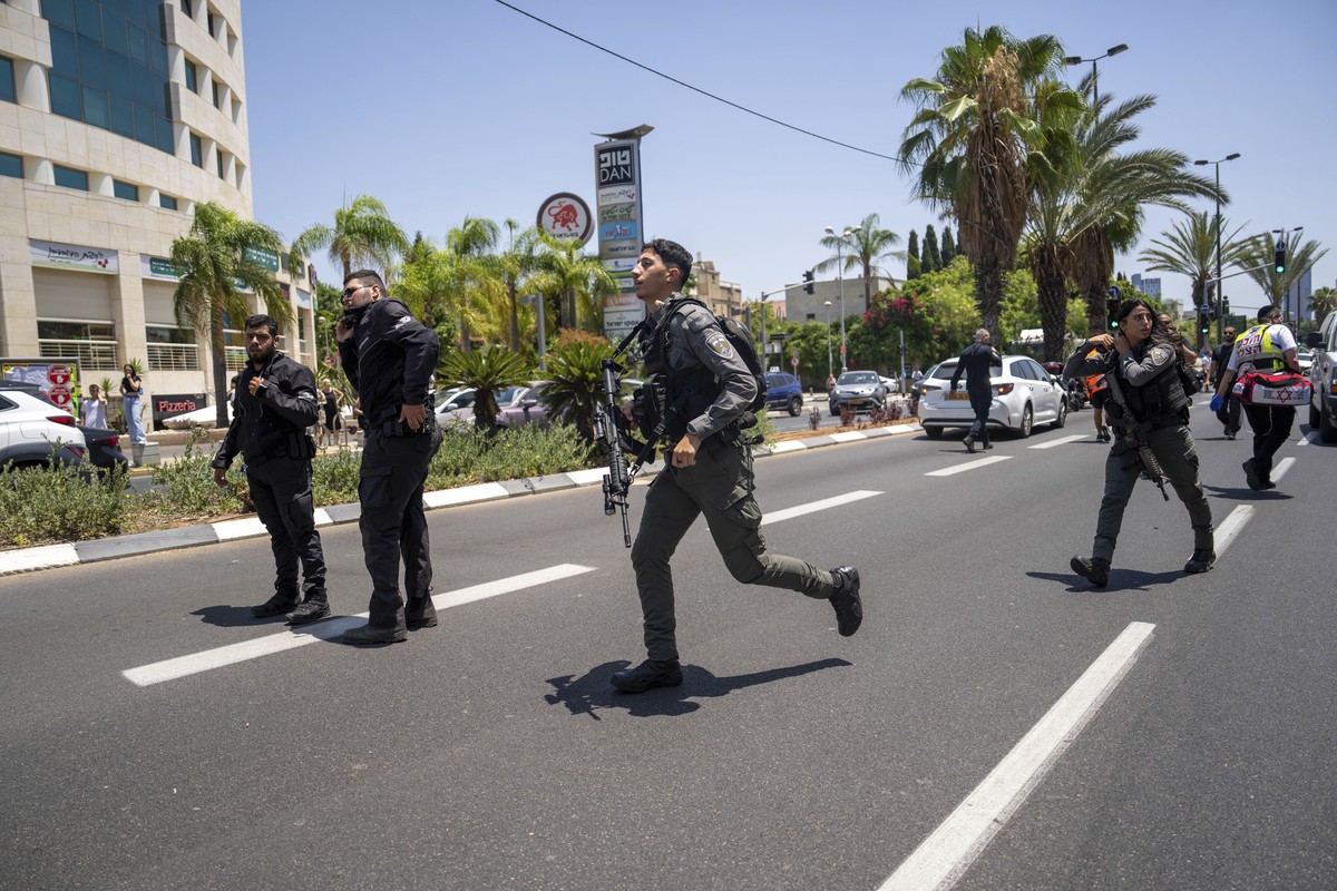 Israeli police are seen at the site of a Palestinian car-ramming attack at a bus stop in Tel Aviv, Israel, Tuesday, July 4, 2023. Israeli paramedics said at least seven people were wounded when the ca ...