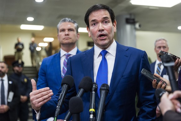 epa12634345 US Secretary of State Marco Rubio (C), alongside Secretary of Defense Pete Hegseth (L), speaks to reporters after briefing US Senators about the capture of Venezuelan President Nicolas Mad ...