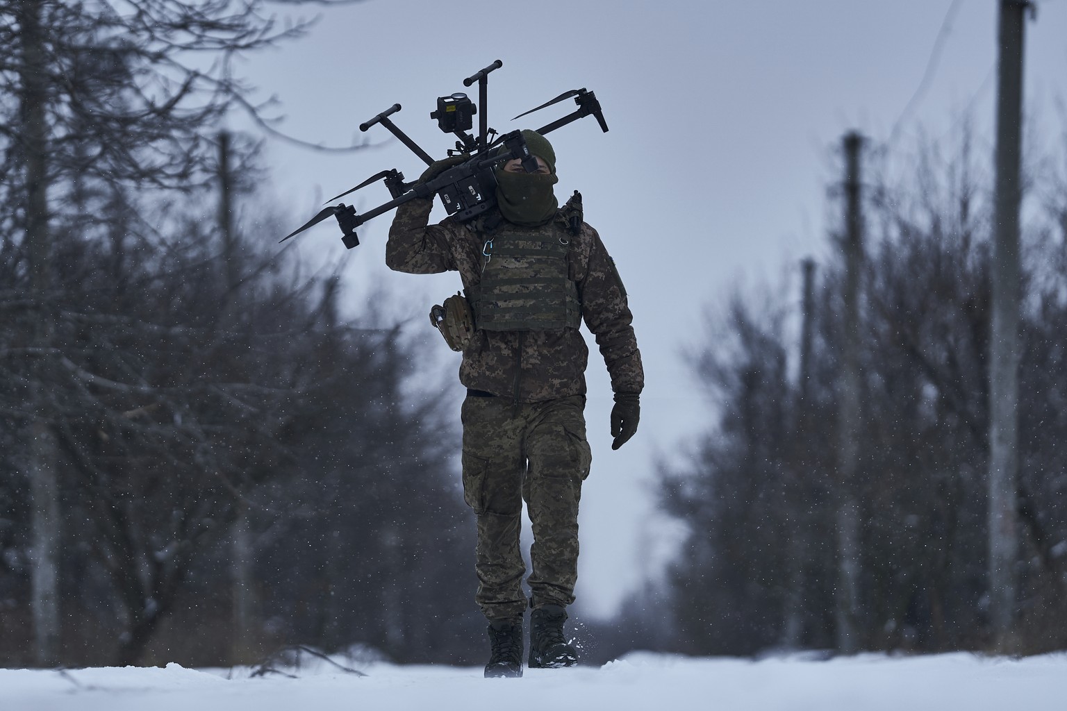 FILE - A Ukrainian soldier carries a drone close to the frontline near Avdiivka, Donetsk region, Ukraine, Friday, Feb. 17, 2023. Ukrainian government is launching a new initiative meant to streamline  ...