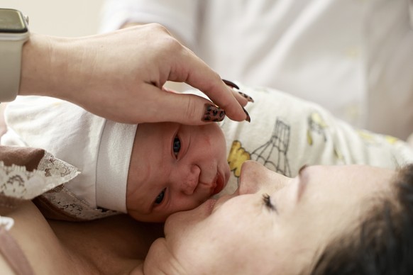 Yulia Ponomarenko kisses her newborn baby Marianna, at the maternity hospital ?7 in Odesa, Ukraine, Monday, Nov. 11, 2024 (AP Photo/Nina Lyashonok)