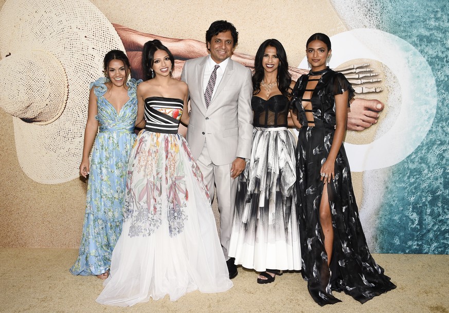 Writer-director-producer M. Night Shyamalan, center, poses with his wife, Bhavna Vaswani, and their daughters Shivani Shyamalan, left, Saleka Shyamalan and Ishani Night Shyamalan, far right, at the wo ...