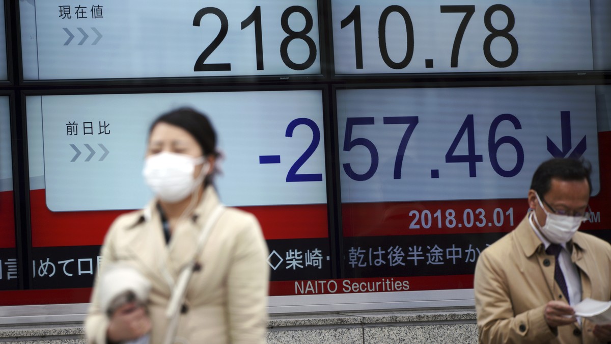 People walk past an electronic stock board showing Japan's Nikkei 225 index at a securities firm in Tokyo, Thursday, March 1, 2018. Asian shares were mostly lower Thursday as sentiments got dragg ...