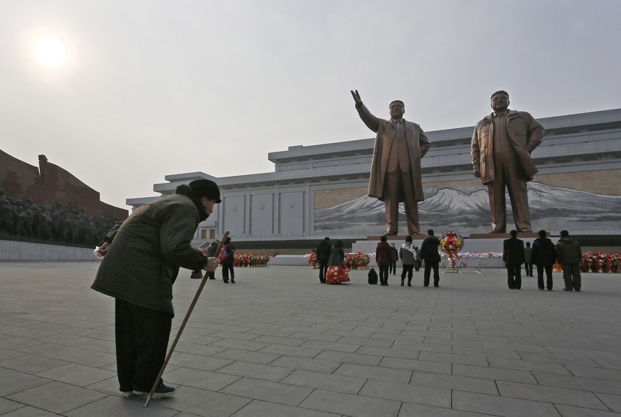 A North Korean elderly man bows before the statues of North Korea&#039;s late leader Kim Jong Il, right, and his father, North Korea&#039;s founder Kim Il Sung, in Pyongyang, North Korea, Sunday, Feb. ...