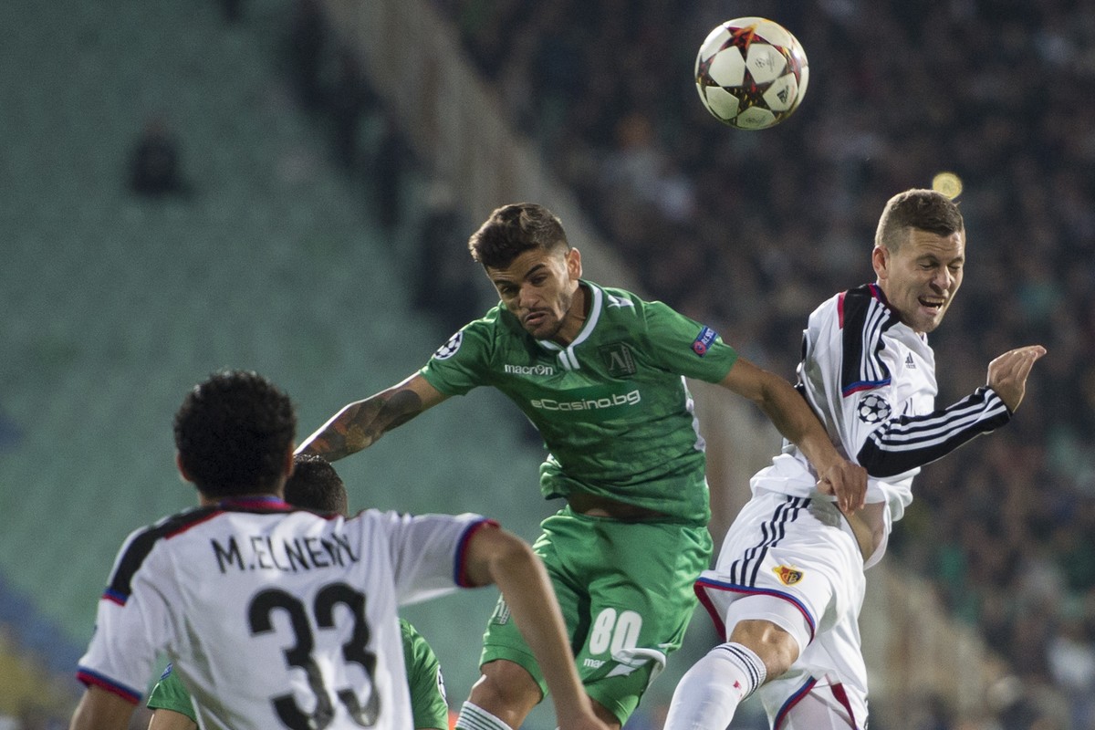 Basel's Fabian Frei, right, fights for the ball against Rasgrad's Uilson de Souza Junior, center, during an UEFA Champions League group B matchday 3 soccer match between Bulgaria's Ludo ...
