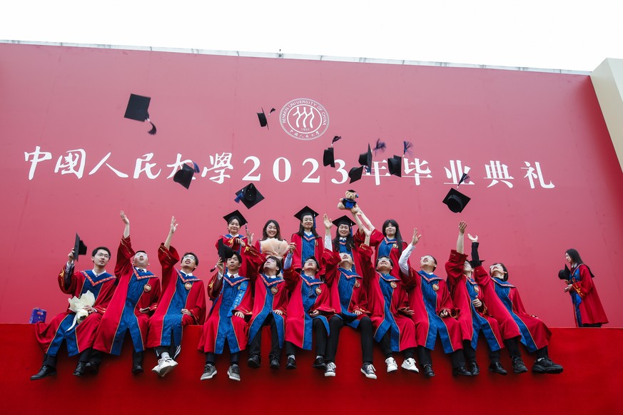 epa10755186 (03/31) Graduates throw their trencher caps after the degree awarding ceremony at Renmin University in Beijing, China, 26 June 2023. China?s young job seekers are faced with record high yo ...