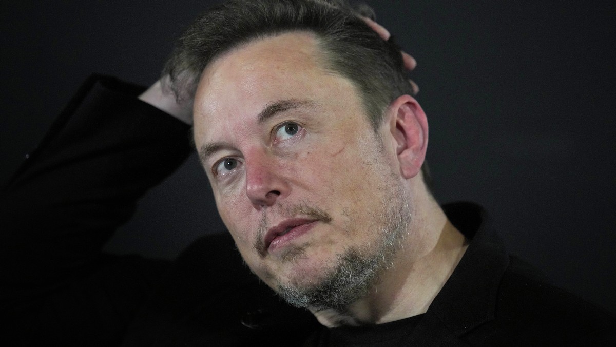 FILE - Elon Musk appears at an event with Britain's Prime Minister Rishi Sunak in London, on Nov. 2, 2023. According to Musk, the first human received an implant from his computer-brain interface ...