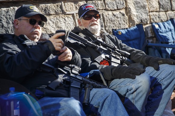 epa08144968 Gun-rights supporters gather for a rally outside the Virginia state capitol in Richmond, Virginia, USA, 20 January 2020. Virginia Citizens Defense League organized the rally to lobby again ...