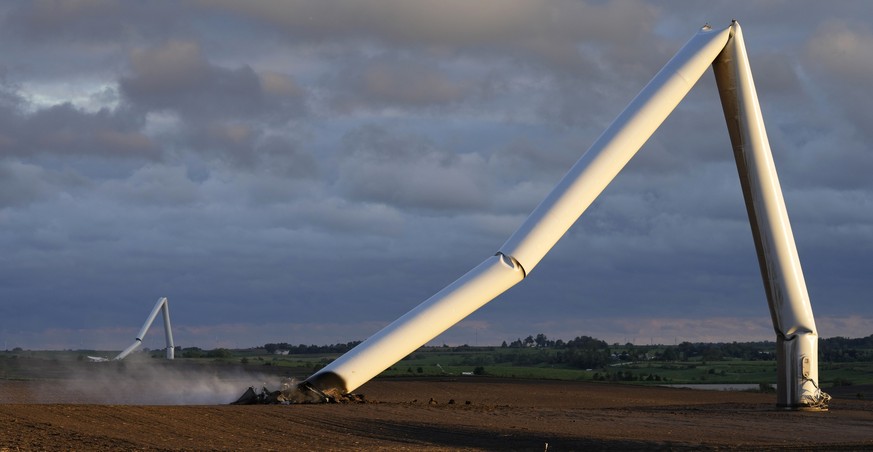 The remains of a tornado-damaged wind turbine touch the ground in a field, Tuesday, May 21, 2024, near Prescott, Iowa. (AP Photo/Charlie Neibergall)