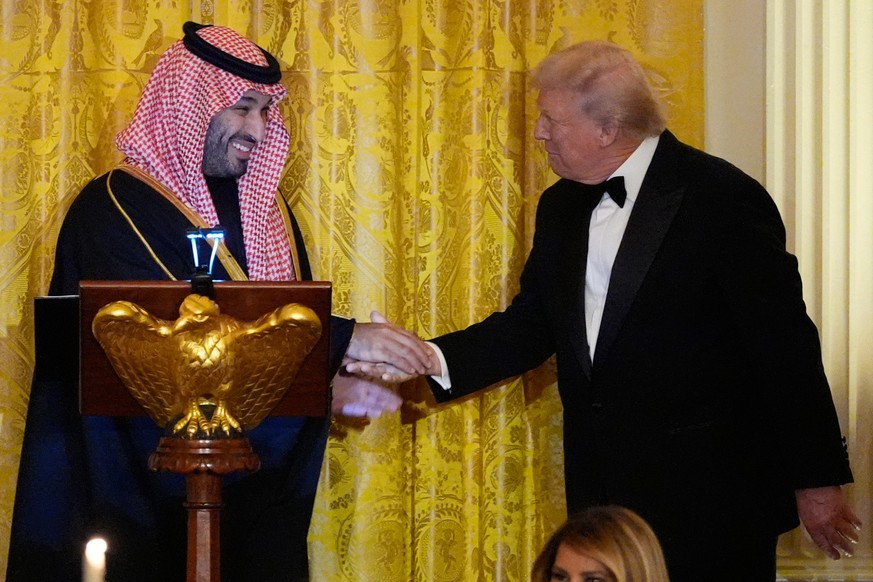 President Donald Trump and Saudi Arabia's Crown Prince Mohammed bin Salman shake hands during a dinner in the East Room of the White House, Tuesday, Nov. 18, 2025, in Washington. (AP Photo/Alex B ...