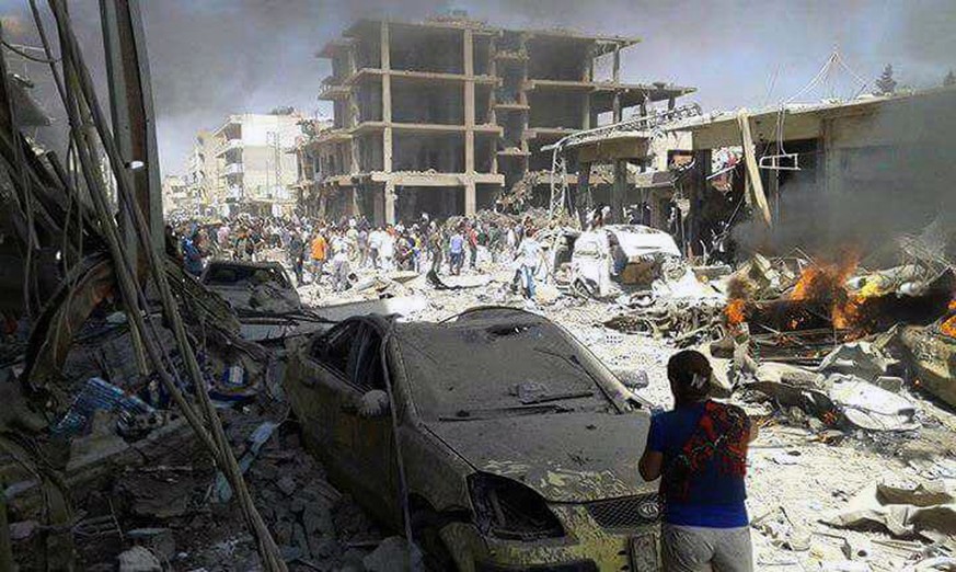 In this photo released by the Syrian official news agency SANA, Syrians inspect damages after deadly twin bombings struck the town of Qamishli, Syria, Wednesday, July 27, 2016. The bombings struck a c ...