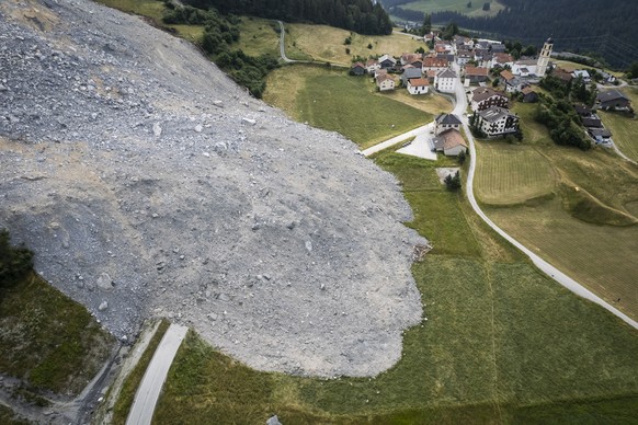 epa10725460 A picture taken with a drone shows an aerial view of the debris flow towards the village, in Brienz-Brinzauls, Switzerland, 04 July 2023. On 15 June, a stream of debris almost reached the  ...