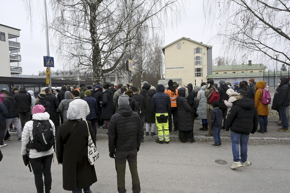 Family members of pupils of the Viertola comprehensive school wait to enter the school, in Vantaa, Finland, Tuesday, April 2, 2024. A 12-year-old student opened fire at a secondary school in southern  ...