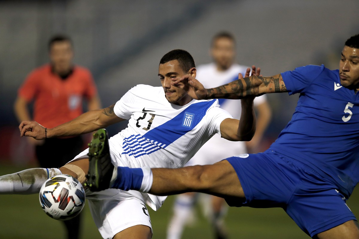 Greece's Giorgos Giakoumakis, left, fights for the ball with Fanos Katelaris during the international friendly soccer match between Greece and Cyprus at Georgios Kamaras in Athens on Wednesday No ...