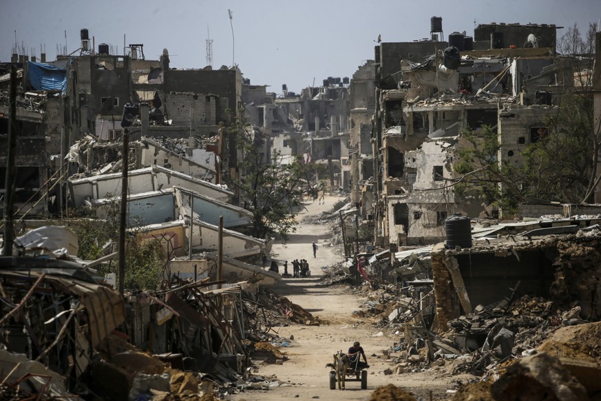 epa11294129 Destroyed buildings as Palestinians return to Khan Younis after the Israeli military pulled out troops from the southern Gaza Strip, 22 April 2024. More than 34,000 Palestinians and over 1 ...
