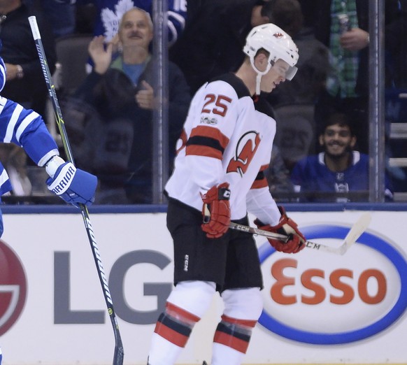 Toronto Maple Leafs&#039; William Nylander, Auston Matthews, Dominic Moore, Nikita Zaitsev and Ron Hainsey, from left, celebrate Moore&#039;s goal as New Jersey Devils&#039; Mirco Mueller (25) skates  ...