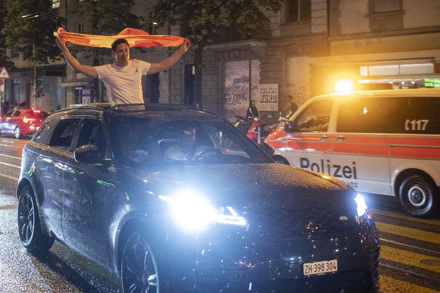 Fans of Switzerland celebrate after the Euro 2020 soccer tournament match between France and Switzerland in Zurich, Switzerland, Monday, June 28, 2021. (KEYSTONE/Ennio Leanza).