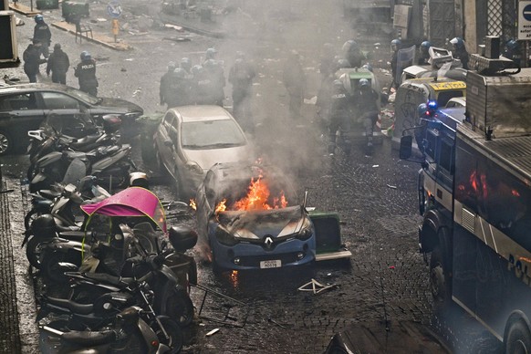 March 15, 2023, NAPLES: Police car set on fire during clashes with Eintracht Frankfurt s supporters in Naples, Italy, 15 March 2023. Napolis and Eintracht Frankfurt will play the UEFA Champions League ...