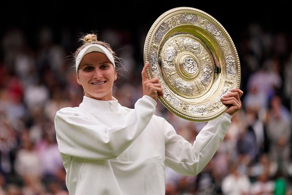 FILE - Czech Republic's Marketa Vondrousova celebrates with the trophy after beating Tunisia's Ons Jabeur to win the final of the women's singles on day thirteen of the Wimbledon tennis ...