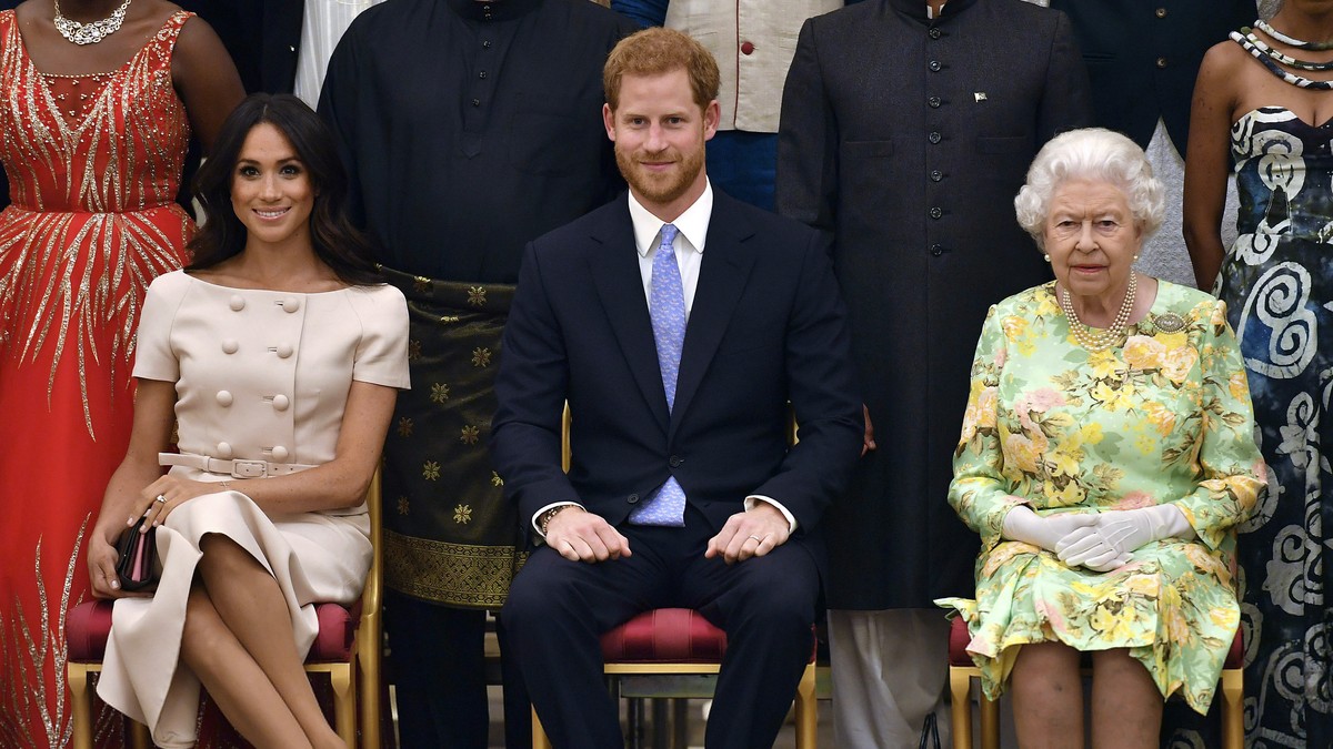 FILE - In this Tuesday, June 26, 2018 file photo Britain's Queen Elizabeth, Prince Harry and Meghan, Duchess of Sussex pose for a group photo at the Queen's Young Leaders Awards Ceremony at  ...