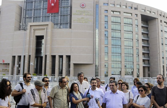 Journalist gather outside a court building to support their colleague journalist Bulent Mumay, who was detained Tuesday in connection with the investigation launched into the failed coup attempt in Tu ...