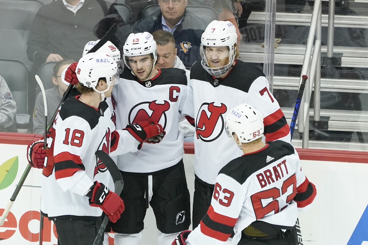 New Jersey Devils' Nico Hischier, center, celebrates with Dawson Mercer (18), Jesper Bratt (63), Dougie Hamilton (7) and Jack Hughes (86) during the third period of an NHL hockey game against the ...